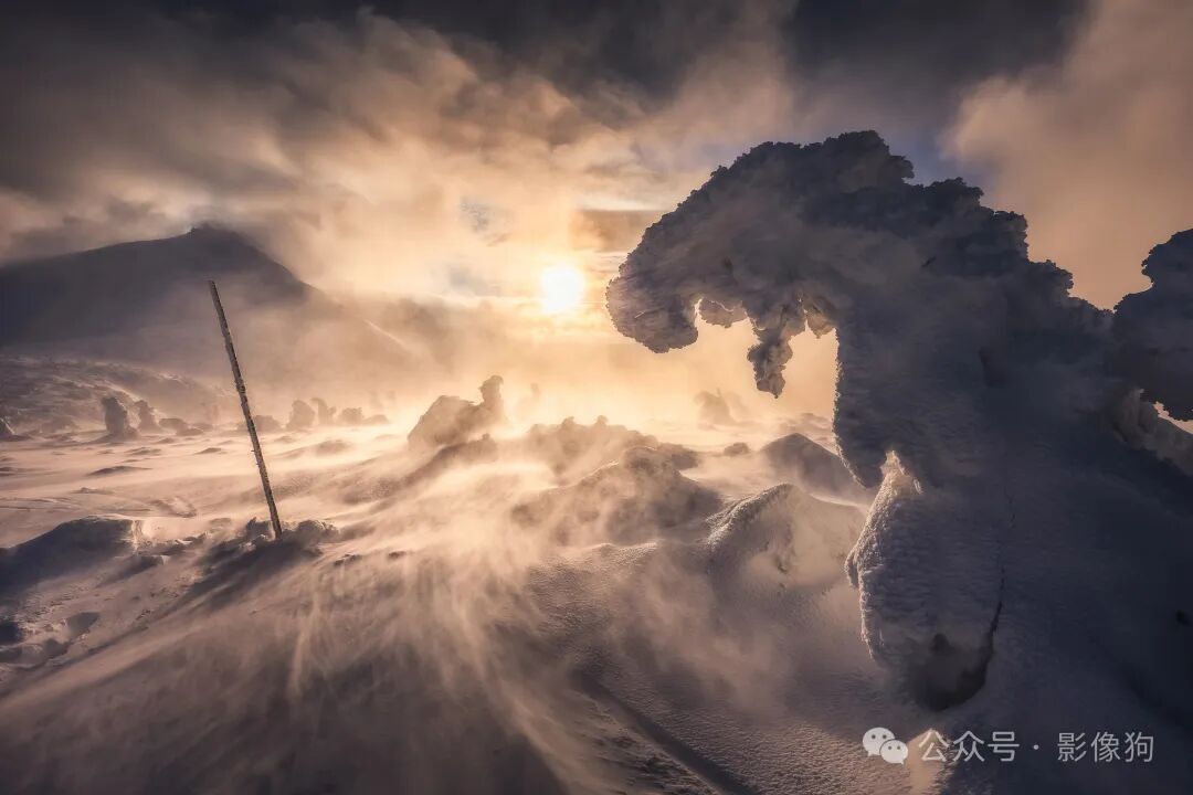 A hanging ice crag with a low sun in the background